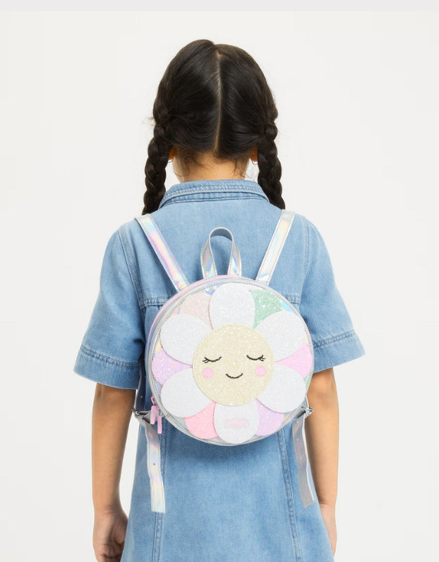 A child wearing a Smiggle flower backpack